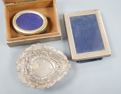 A silver mounted cigarette box, a silver bonbon dish and two photo graph frames including silver.